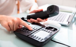 Woman Dialing Landline Phone