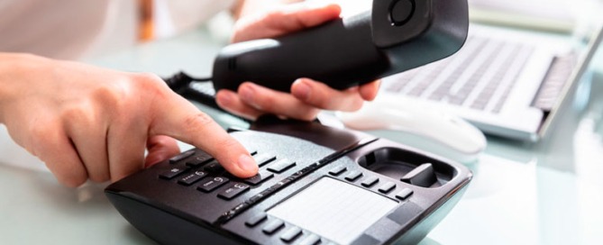 Woman Dialing Landline Phone